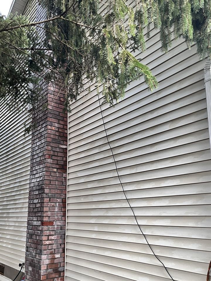 The same chimney side washed back to clean siding