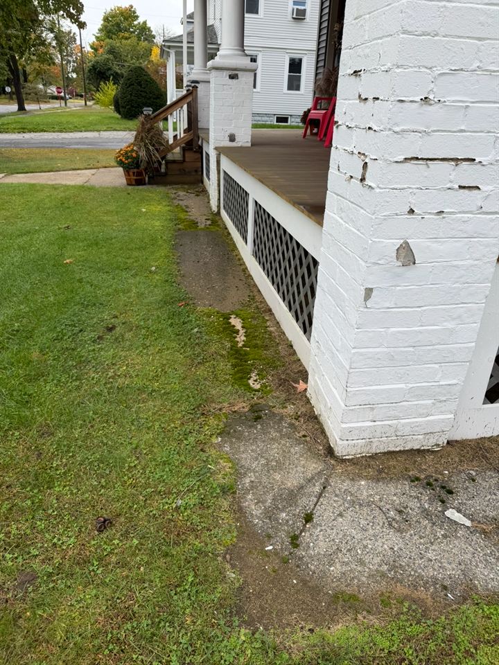 Walkway at the porch corner with moss along the edge